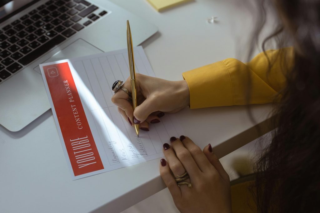 Writing out a plan on how to create short form video content for YouTube
